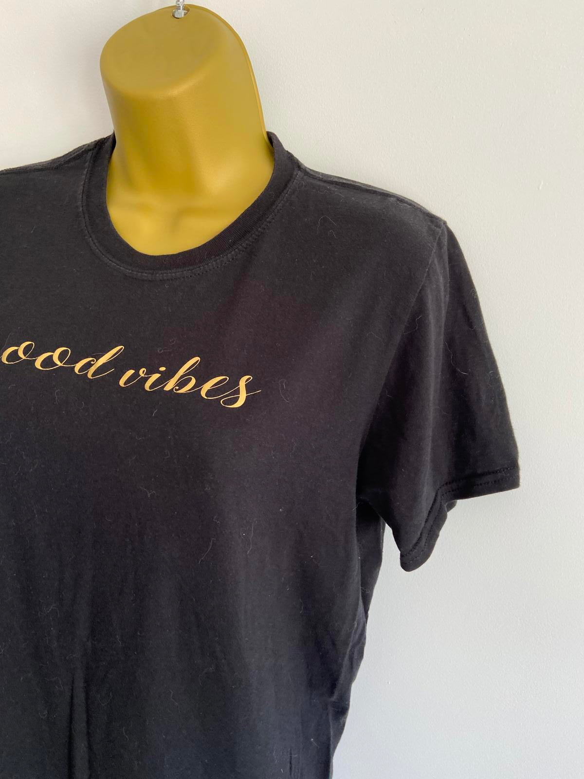 Medium Black T-shirt with the writing in gold 'Good Vibes'
